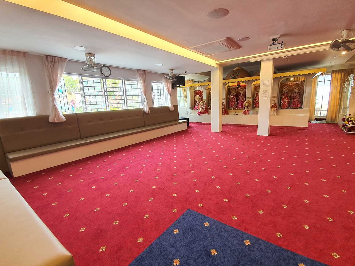 The Prayer Hall at Sindhu House, with its shrines and carpeted floor